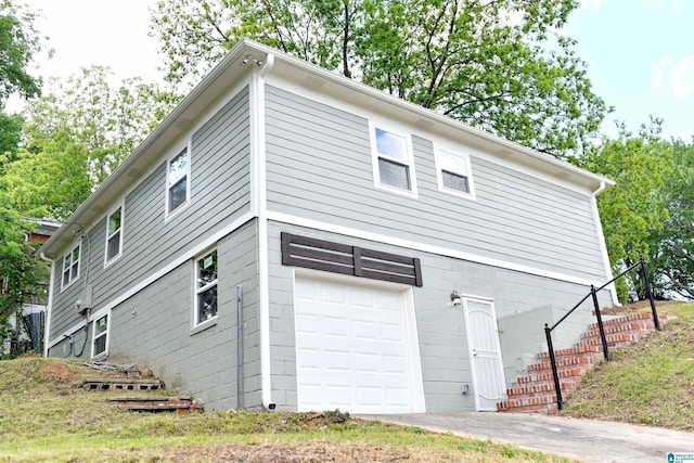 1545 32nd St, Birmingham, AL 35218 - view of side of property featuring a garage and stairway
