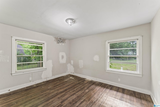 empty room featuring hardwood / wood-style floors and baseboards