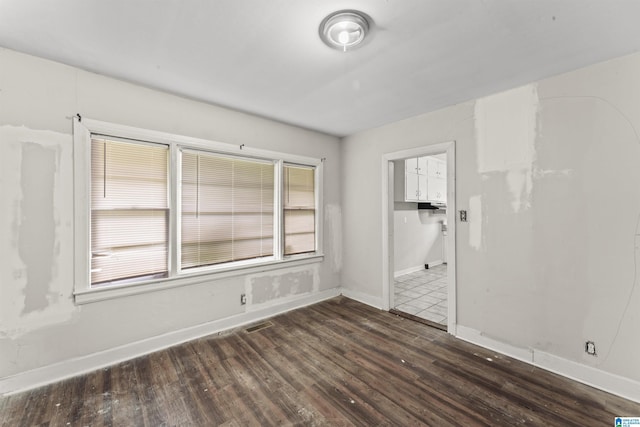 empty room with wood finished floors and baseboards
