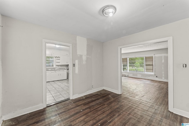 spare room featuring wood finished floors and baseboards