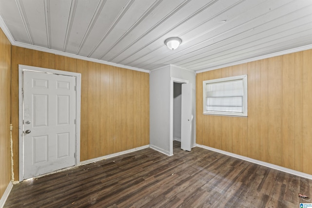 unfurnished bedroom with dark wood-style floors, ornamental molding, wood ceiling, a closet, and wood walls