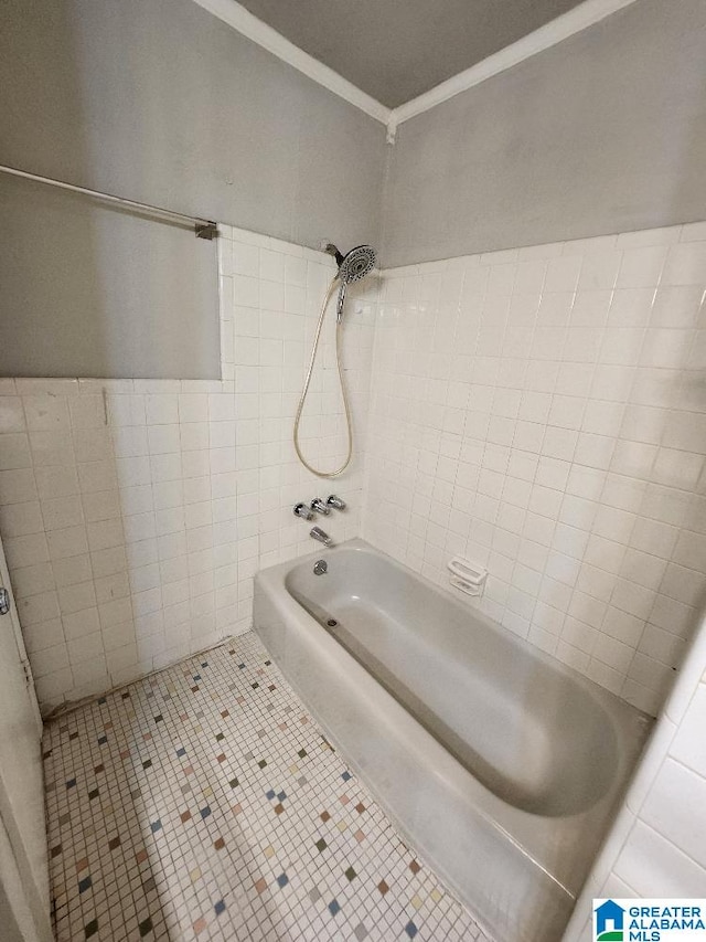 bathroom featuring crown molding, tile walls, tile patterned flooring, and  shower combination