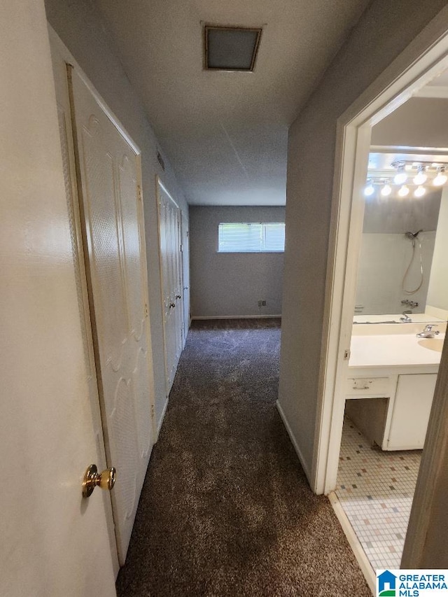 hallway with carpet flooring and baseboards