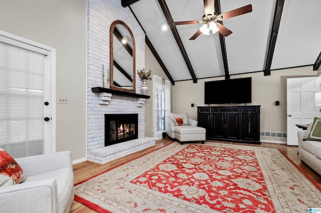 2673 Buckboard Rd, Birmingham, AL 35244 - living room featuring beamed ceiling, wood finished floors, a ceiling fan, a brick fireplace, and high vaulted ceiling