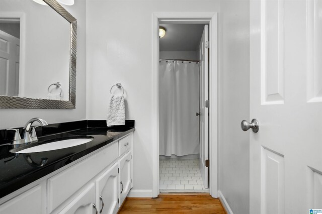 2673 Buckboard Rd, Birmingham, AL 35244 - bathroom featuring vanity, baseboards, wood finished floors, and curtained shower