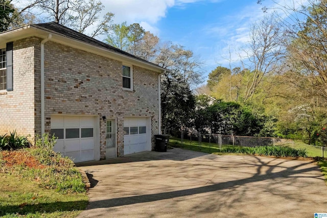2673 Buckboard Rd, Birmingham, AL 35244 - view of home's exterior with a garage, fence, driveway, and brick siding