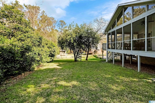 2673 Buckboard Rd, Birmingham, AL 35244 - view of grassy yard featuring stairway, a sunroom, and a ceiling fan