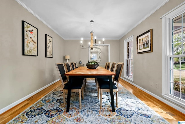 2673 Buckboard Rd, Birmingham, AL 35244 - dining area with a chandelier, light wood-style flooring, baseboards, and ornamental molding