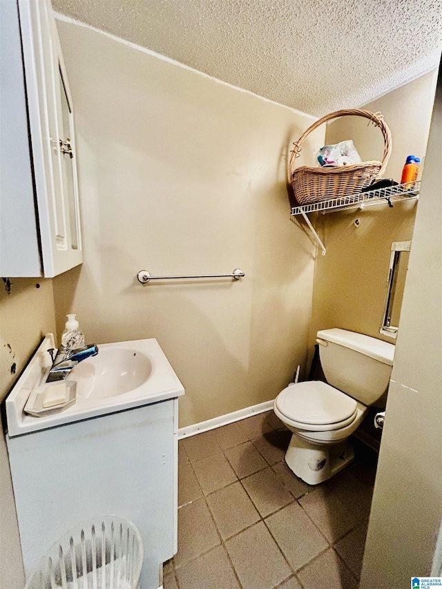 1 Annie Humber Rd, Adger, AL 35006 - bathroom with a textured ceiling, toilet, vanity, baseboards, and tile patterned floors