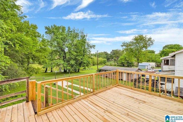 deck featuring a lawn and view of scattered trees