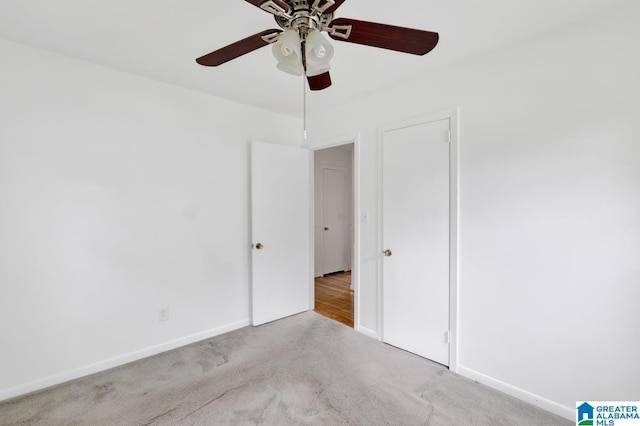 unfurnished bedroom with carpet, baseboards, and a ceiling fan