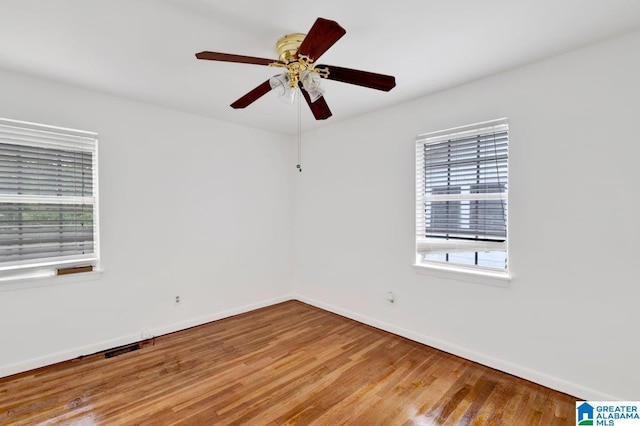 empty room with baseboards, light wood-style floors, and ceiling fan