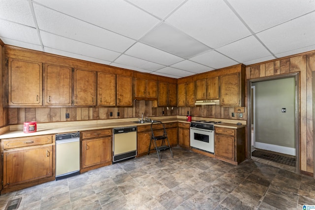 315 W Parkway Ave, Talladega, AL 35160 - kitchen with white stove, dishwasher, brown cabinetry, a sink, and a drop ceiling