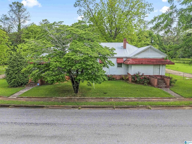315 W Parkway Ave, Talladega, AL 35160 - ranch-style house with a front yard, metal roof, and a chimney