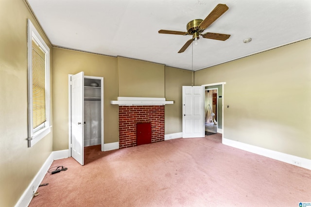 315 W Parkway Ave, Talladega, AL 35160 - unfurnished living room featuring a brick fireplace, a ceiling fan, carpet floors, and baseboards
