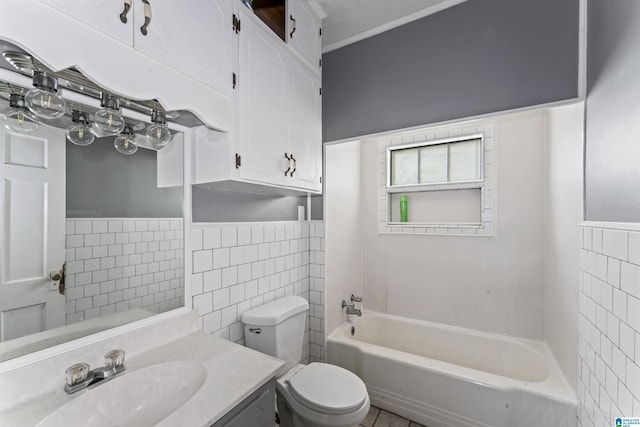 315 W Parkway Ave, Talladega, AL 35160 - bathroom featuring tile walls, toilet, vanity, and a wainscoted wall