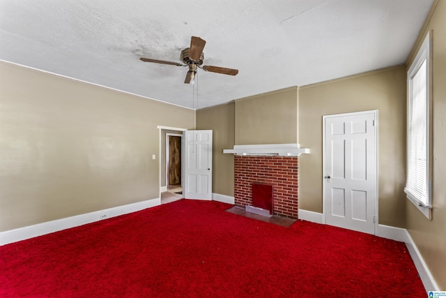 315 W Parkway Ave, Talladega, AL 35160 - unfurnished living room featuring ceiling fan, baseboards, a brick fireplace, and carpet floors