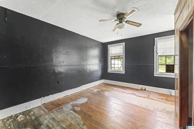 315 W Parkway Ave, Talladega, AL 35160 - spare room with baseboards, hardwood / wood-style flooring, a textured ceiling, and ceiling fan