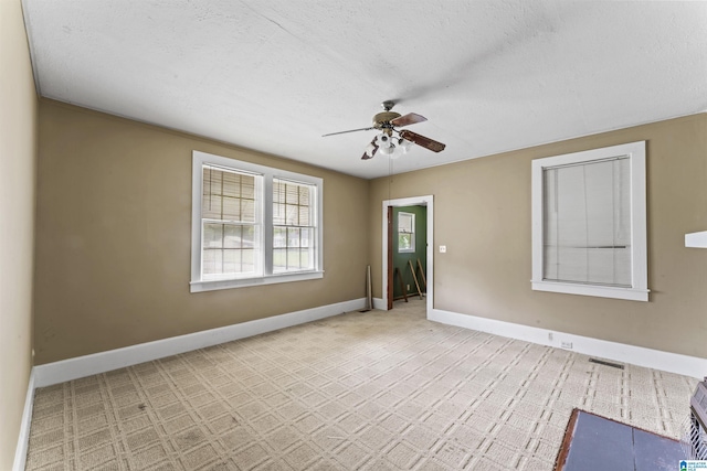 315 W Parkway Ave, Talladega, AL 35160 - carpeted empty room with ceiling fan, baseboards, and a textured ceiling