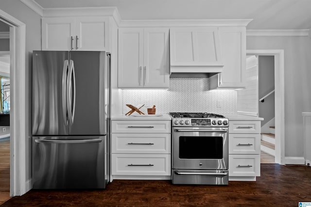 2208 Garland Dr, Vestavia Hills, AL 35216 - kitchen featuring appliances with stainless steel finishes, light countertops, backsplash, ornamental molding, and white cabinets