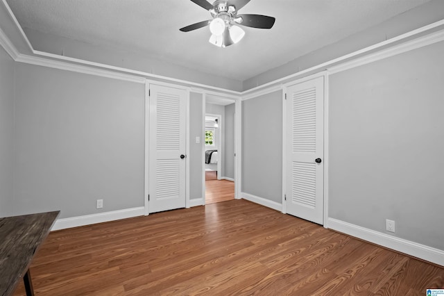 2208 Garland Dr, Vestavia Hills, AL 35216 - empty room with wood finished floors, a ceiling fan, and baseboards