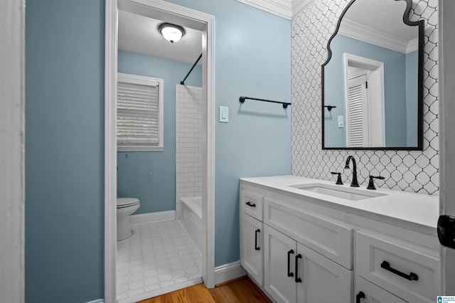 2208 Garland Dr, Vestavia Hills, AL 35216 - full bath featuring toilet, ornamental molding, a textured ceiling, vanity, and backsplash