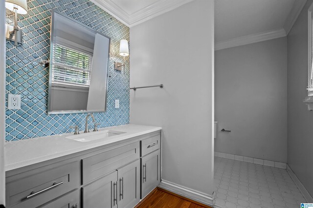 2208 Garland Dr, Vestavia Hills, AL 35216 - bathroom with ornamental molding, tile walls, vanity, and baseboards