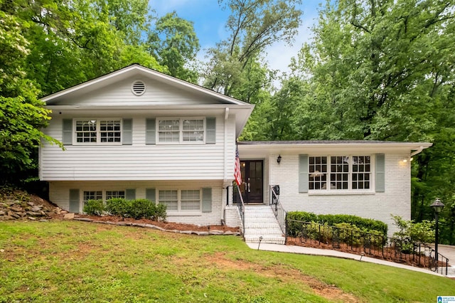 2208 Garland Dr, Vestavia Hills, AL 35216 - tri-level home with a front lawn and brick siding
