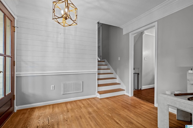 2208 Garland Dr, Vestavia Hills, AL 35216 - foyer featuring ornamental molding, wood finished floors, stairway, baseboards, and a chandelier