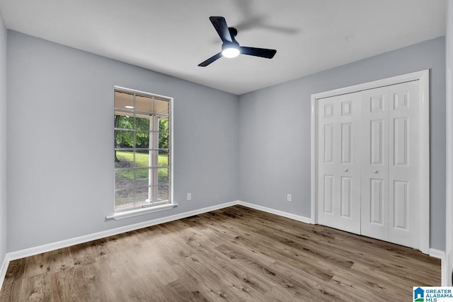 5457 Snowville Brent Rd, Dora, AL 35062 - unfurnished bedroom with wood finished floors, baseboards, a closet, and ceiling fan