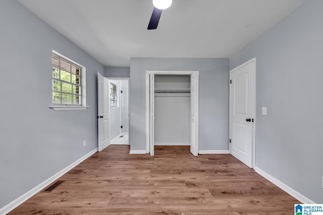 5457 Snowville Brent Rd, Dora, AL 35062 - unfurnished bedroom with wood finished floors, baseboards, a closet, and a ceiling fan