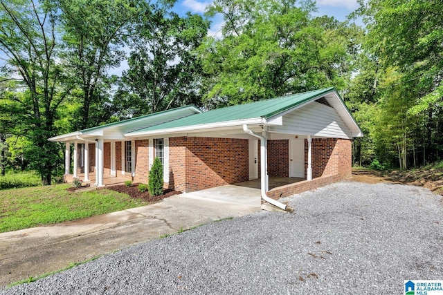 5457 Snowville Brent Rd, Dora, AL 35062 - ranch-style house featuring concrete driveway, brick siding, a carport, and a porch