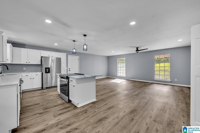 5457 Snowville Brent Rd, Dora, AL 35062 - kitchen featuring appliances with stainless steel finishes, a ceiling fan, recessed lighting, a sink, and light wood-type flooring