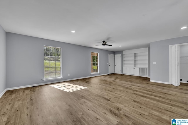 5457 Snowville Brent Rd, Dora, AL 35062 - unfurnished bedroom featuring baseboards, multiple windows, wood finished floors, two closets, and recessed lighting