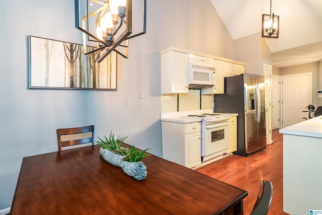 1834 Brandon Way, Bessemer, AL 35022 - dining space with a chandelier, high vaulted ceiling, and wood finished floors