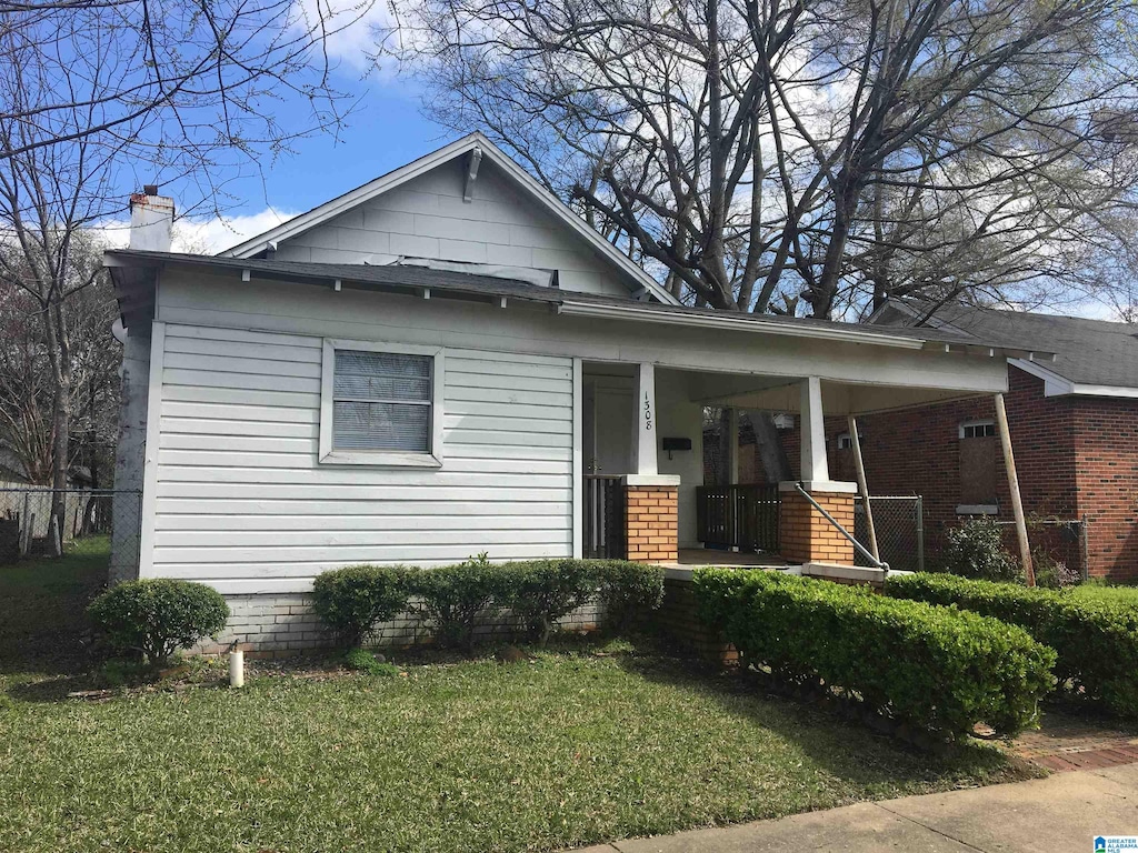 1308 Sloan Ave, Tarrant, AL 35217 - view of front of house with a porch, a chimney, and a front lawn