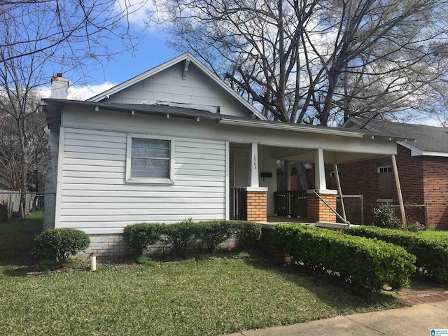 1308 Sloan Ave, Tarrant, AL 35217 - view of front of house with a porch, a chimney, and a front lawn