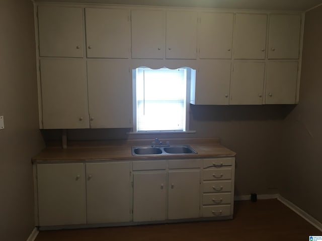 1308 Sloan Ave, Tarrant, AL 35217 - kitchen with a sink, white cabinetry, and baseboards