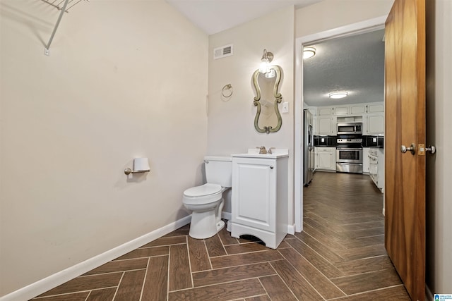 402 S 8th St, Gadsden, AL 35901 - half bath with toilet, baseboards, and vanity