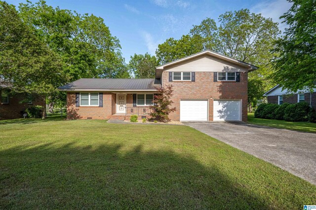 402 S 8th St, Gadsden, AL 35901 - split level home featuring brick siding, covered porch, a garage, a front lawn, and driveway
