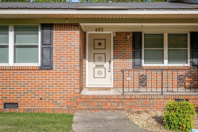 402 S 8th St, Gadsden, AL 35901 - view of exterior entry with covered porch, brick siding, and crawl space