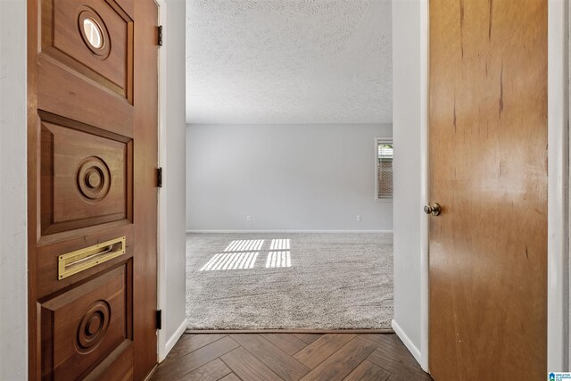 402 S 8th St, Gadsden, AL 35901 - hallway with baseboards, dark colored carpet, and a textured ceiling