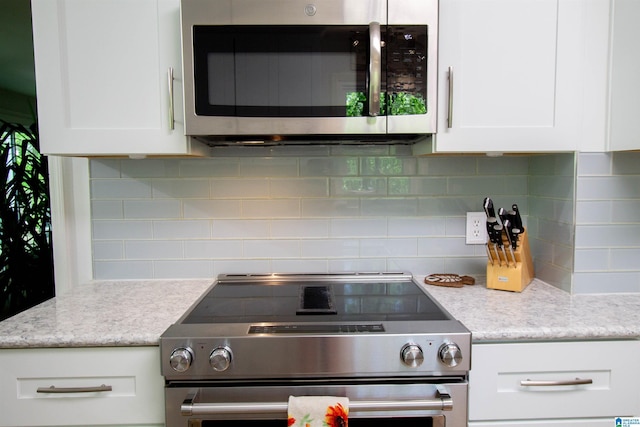 2009 Crossvine Rd, Hoover, AL 35244 - kitchen featuring stainless steel appliances, white cabinetry, and backsplash