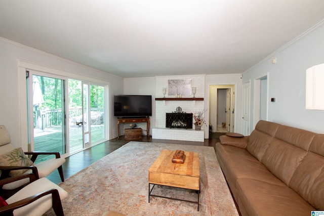 2009 Crossvine Rd, Hoover, AL 35244 - living area featuring dark wood-type flooring, crown molding, and a brick fireplace