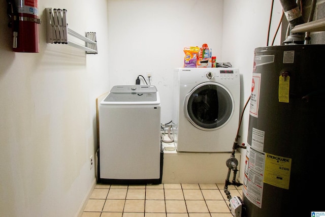 2009 Crossvine Rd, Hoover, AL 35244 - laundry room with gas water heater, washing machine and clothes dryer, and light tile patterned flooring
