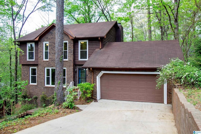 2009 Crossvine Rd, Hoover, AL 35244 - view of front of home featuring an attached garage, concrete driveway, and brick siding