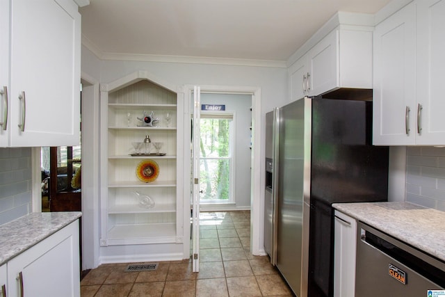 2009 Crossvine Rd, Hoover, AL 35244 - kitchen with appliances with stainless steel finishes, white cabinetry, light countertops, backsplash, and ornamental molding