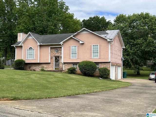 113 Fairlane Dr, Pleasant Grove, AL 35127 - raised ranch featuring a garage, concrete driveway, a chimney, a front lawn, and brick siding