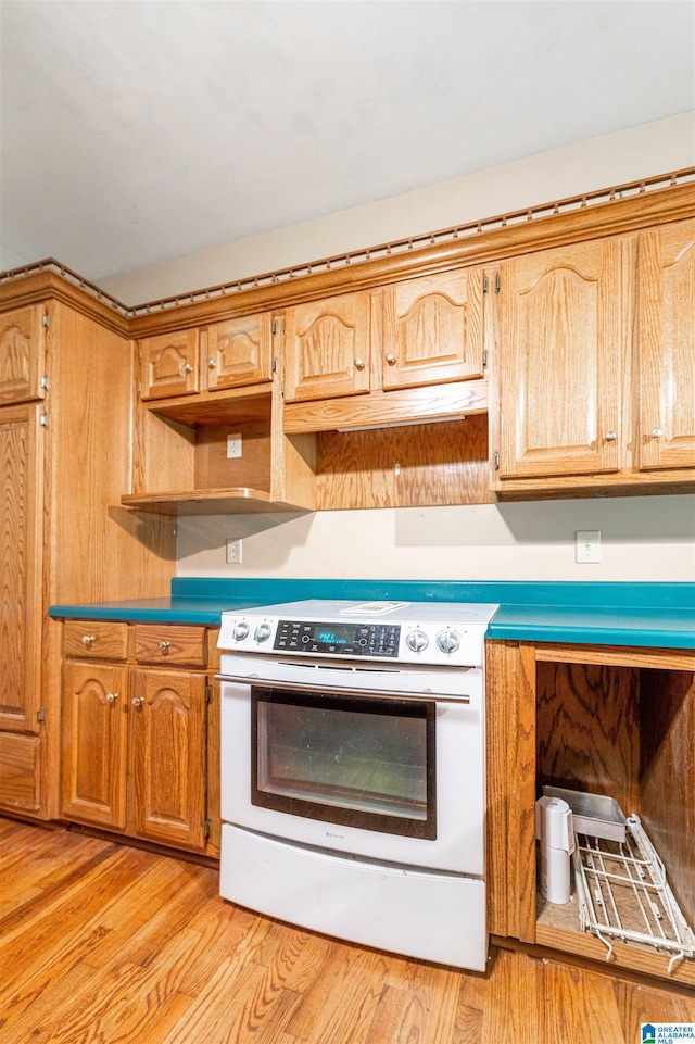 kitchen featuring white electric stove and light wood-style floors