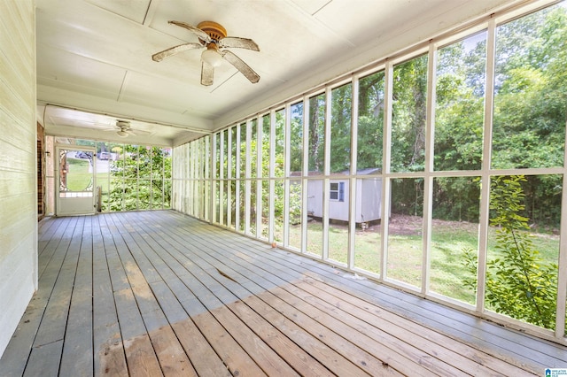 unfurnished sunroom with ceiling fan